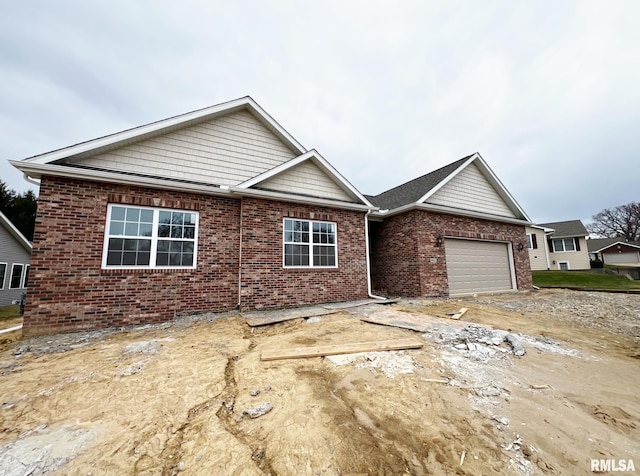 ranch-style house with a garage and brick siding