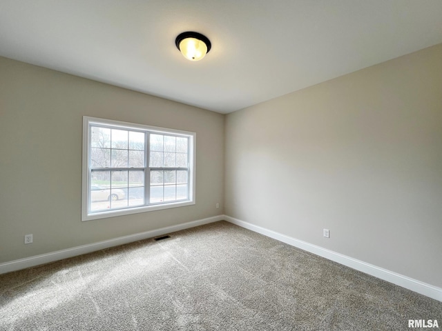carpeted empty room with baseboards and visible vents
