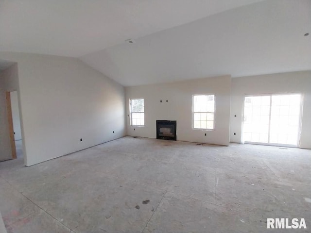 unfurnished living room with lofted ceiling