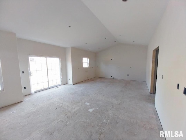 unfurnished room featuring lofted ceiling