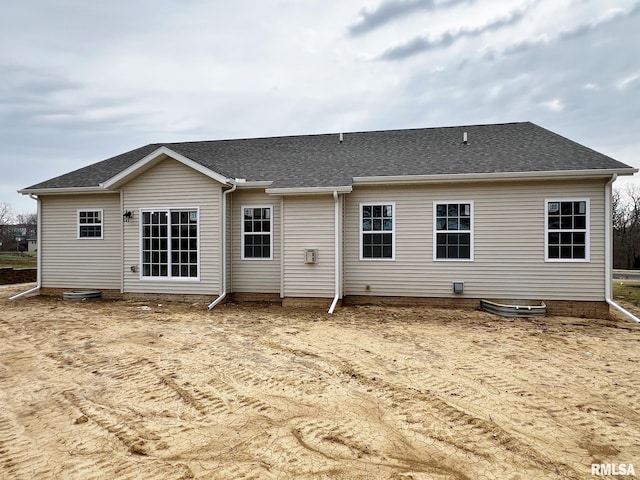rear view of house with a shingled roof