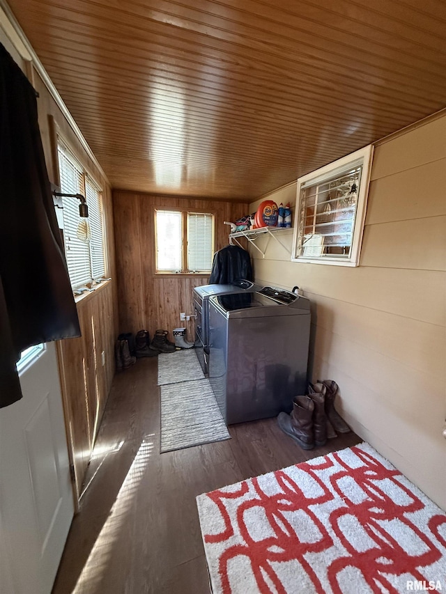 washroom with dark wood-type flooring, independent washer and dryer, wooden walls, and wooden ceiling