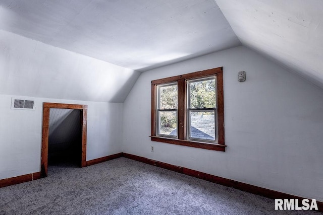 bonus room featuring vaulted ceiling and carpet flooring