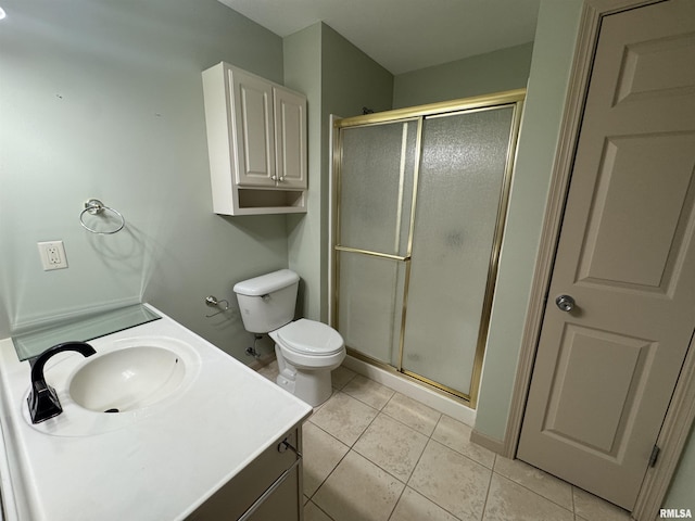 bathroom featuring vanity, tile patterned flooring, a shower with shower door, and toilet