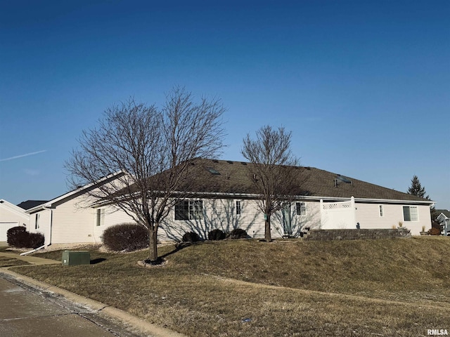 ranch-style home with a front lawn