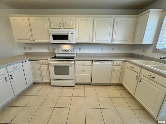 kitchen featuring white cabinetry, light tile patterned flooring, sink, and white appliances