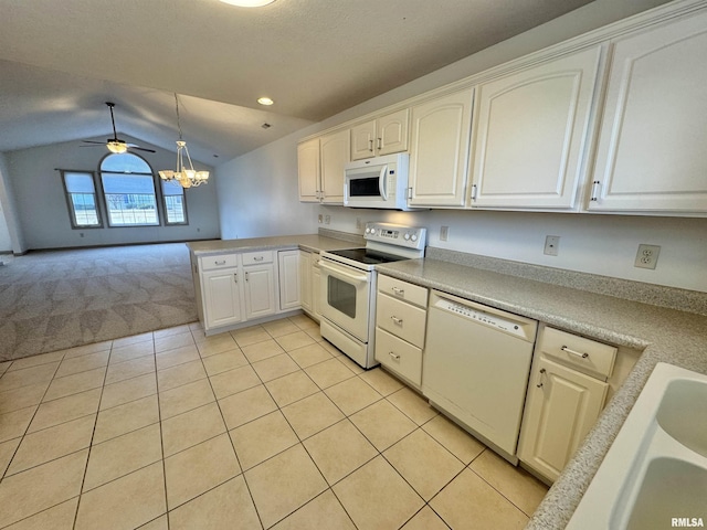 kitchen with lofted ceiling, light tile patterned floors, white appliances, white cabinetry, and hanging light fixtures