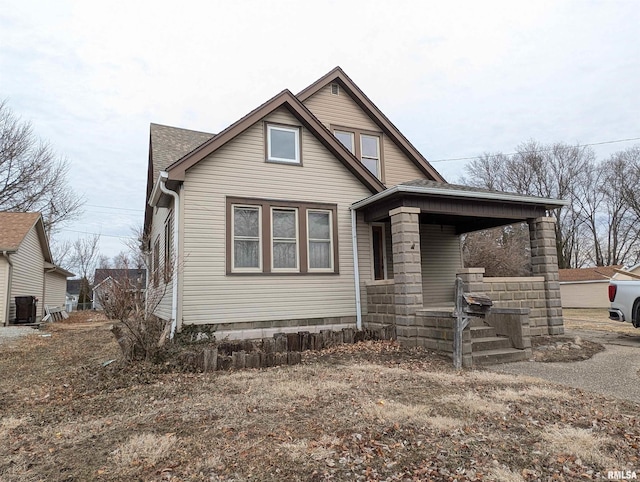 view of front of property featuring cooling unit and a porch