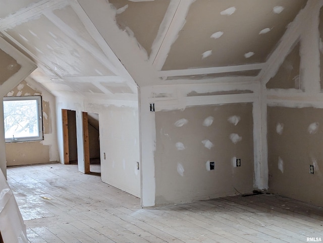 unfurnished room featuring lofted ceiling