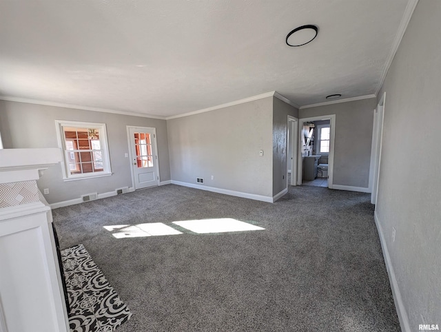 unfurnished living room with crown molding, dark carpet, and a wealth of natural light