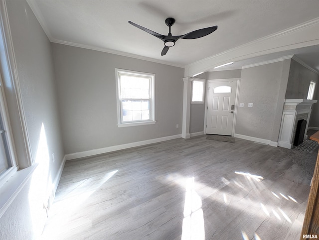 foyer entrance with crown molding, ceiling fan, and light hardwood / wood-style flooring