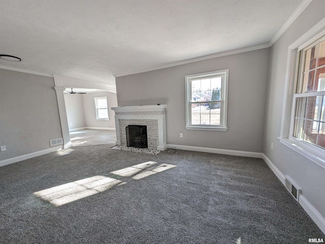 unfurnished living room with crown molding, carpet, and a textured ceiling