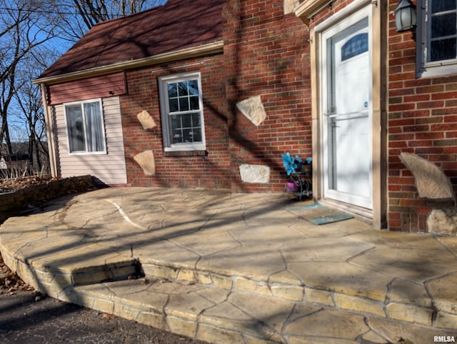 property entrance featuring a patio area