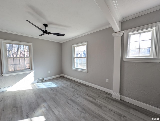 spare room with crown molding, ceiling fan, and light wood-type flooring