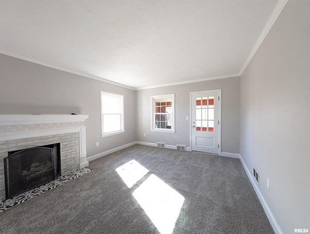 unfurnished living room featuring crown molding, carpet flooring, a wealth of natural light, and a fireplace