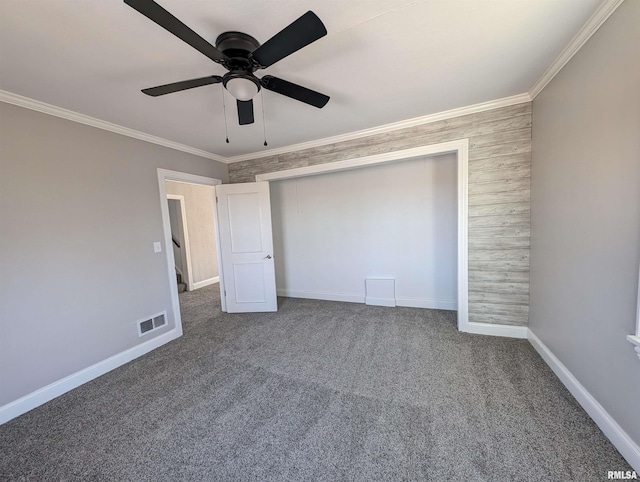 unfurnished bedroom featuring crown molding, carpet, ceiling fan, and a closet