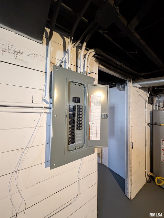 utility room featuring electric panel and water heater