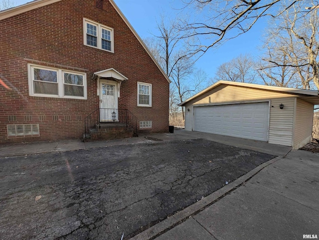 view of front of home with a garage and an outdoor structure