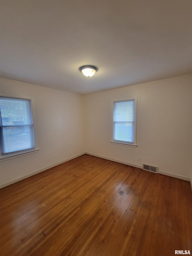 spare room with hardwood / wood-style floors