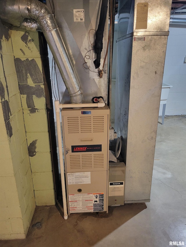 utility room featuring heating unit