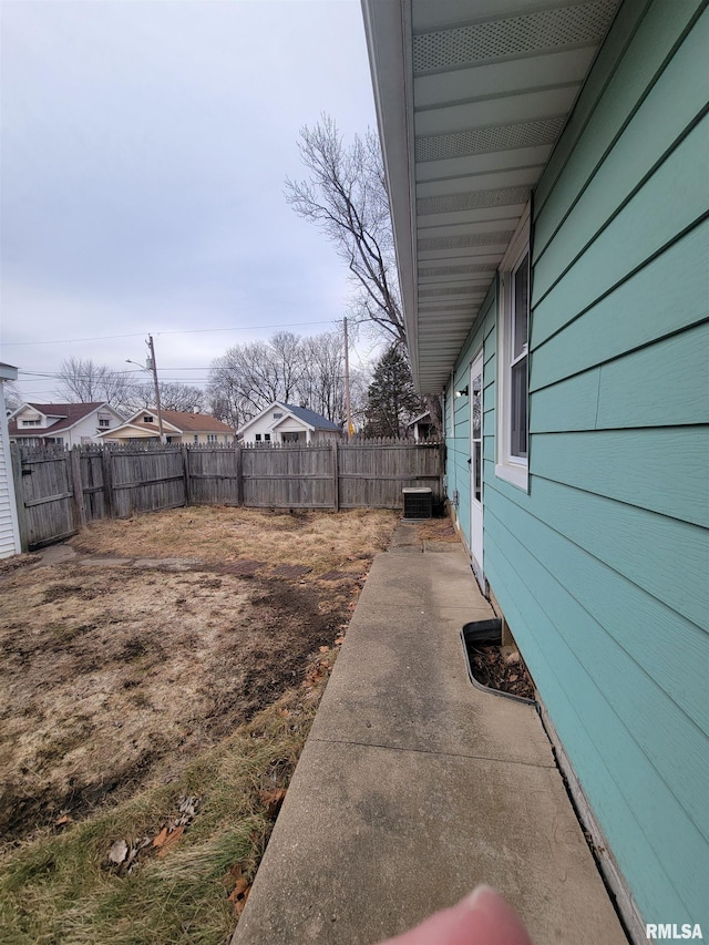 view of yard with cooling unit and a patio