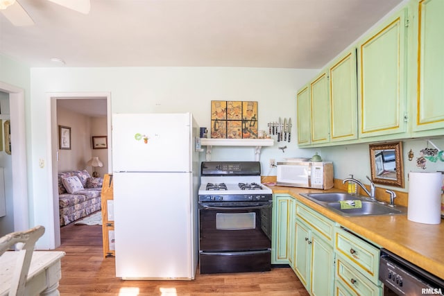 kitchen featuring white appliances, light hardwood / wood-style floors, sink, and green cabinetry