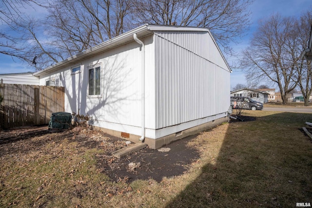 view of side of home with a yard