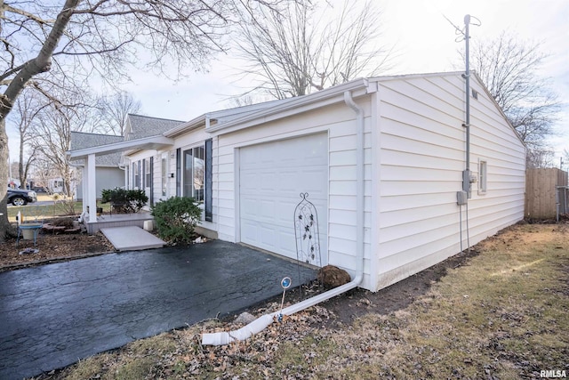 view of home's exterior featuring a garage and a porch