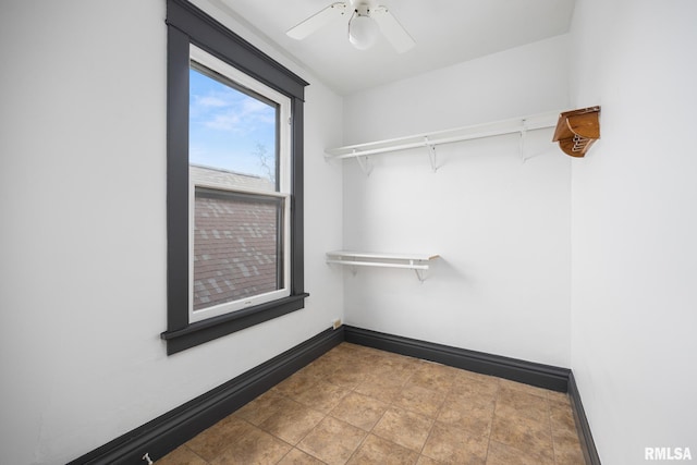 walk in closet with ceiling fan