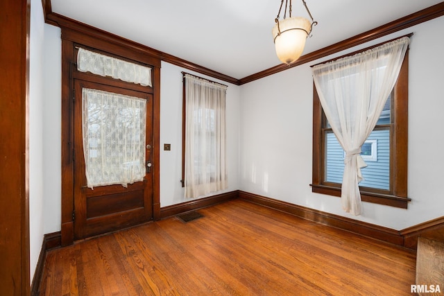 entrance foyer featuring hardwood / wood-style flooring and ornamental molding