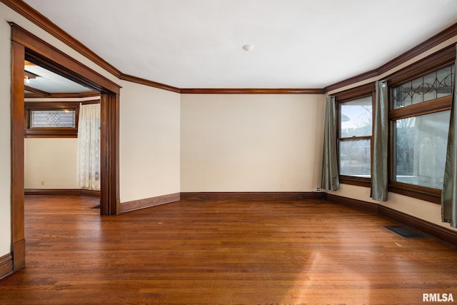 empty room featuring ornamental molding and dark hardwood / wood-style floors