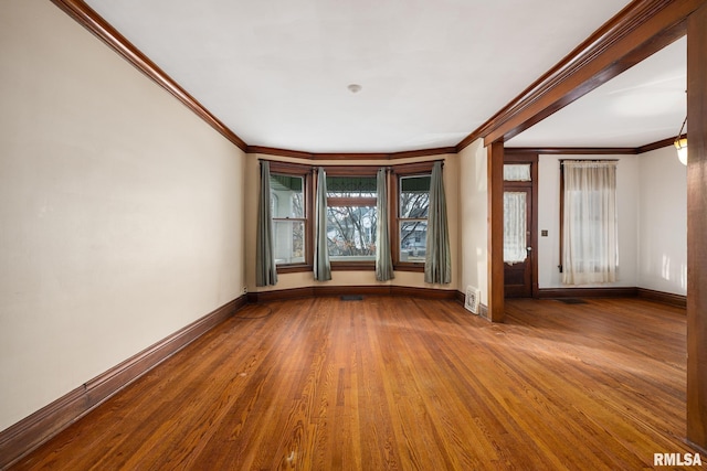 interior space with hardwood / wood-style flooring and ornamental molding