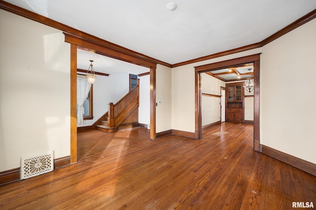 empty room featuring ornamental molding and dark hardwood / wood-style flooring