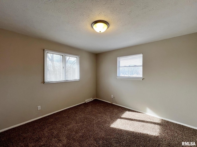 spare room with carpet floors and a textured ceiling