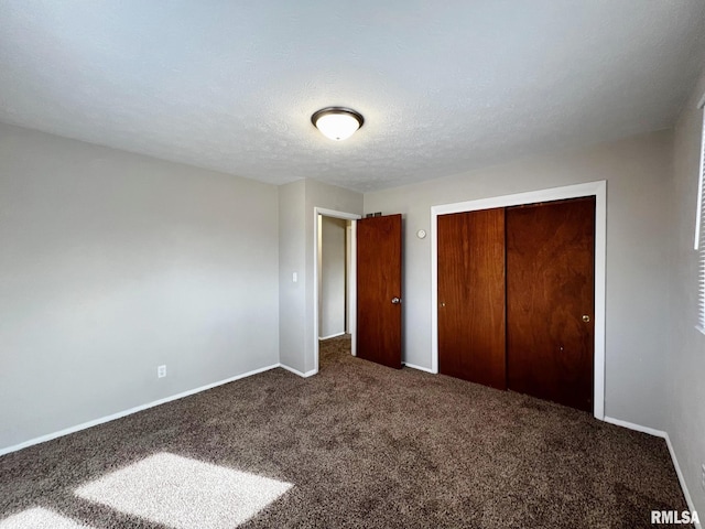 unfurnished bedroom with a closet, a textured ceiling, and carpet