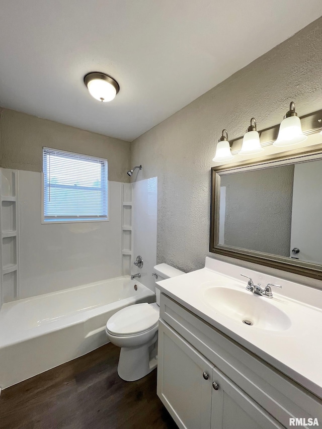 full bathroom with vanity, hardwood / wood-style floors, bathtub / shower combination, and toilet