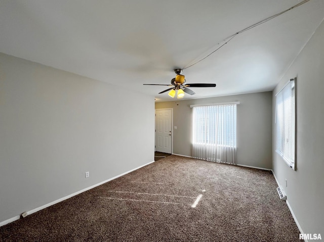 spare room featuring carpet and ceiling fan