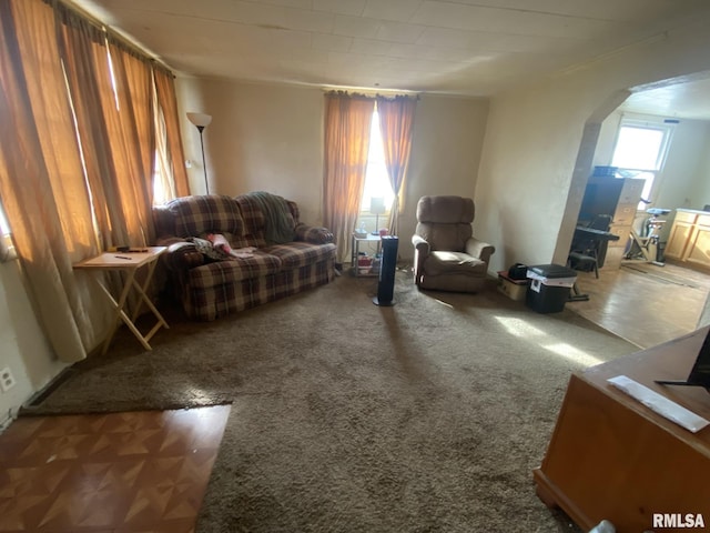 sitting room featuring dark colored carpet