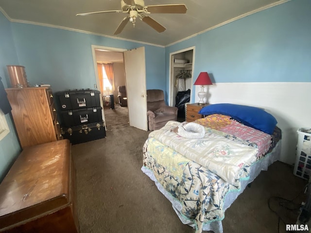 bedroom with crown molding, a closet, ceiling fan, and dark colored carpet