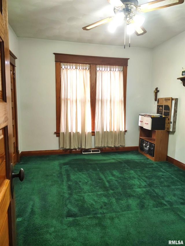 interior space featuring ceiling fan and dark colored carpet