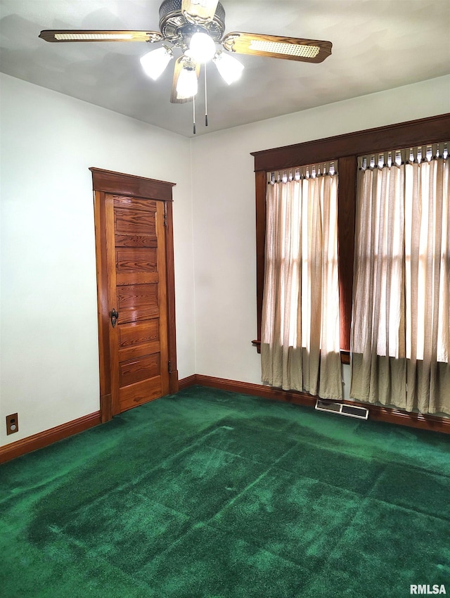 spare room featuring carpet floors and ceiling fan