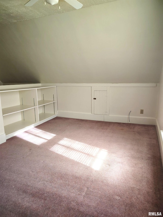 additional living space featuring ceiling fan and carpet