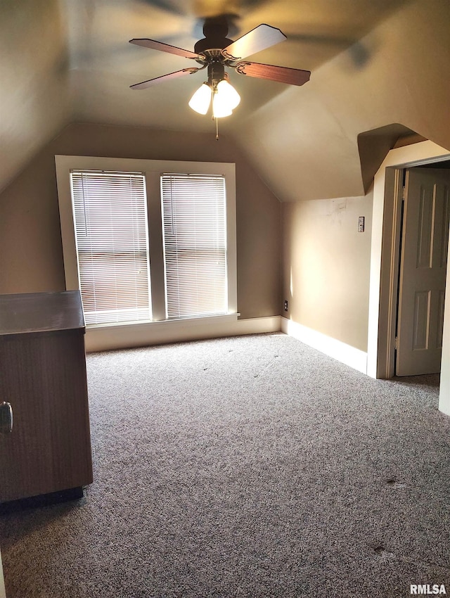 additional living space featuring lofted ceiling, carpet flooring, and ceiling fan