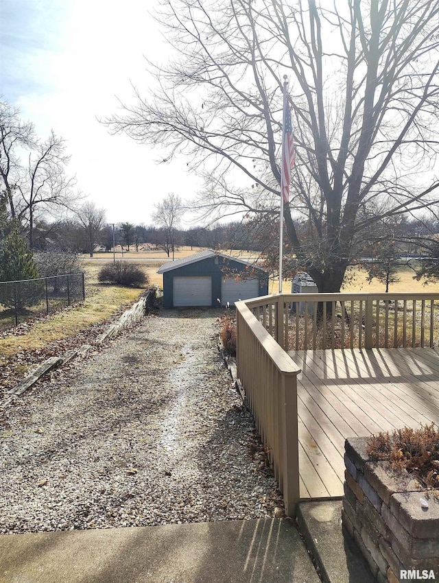 exterior space with a garage, an outbuilding, and a rural view