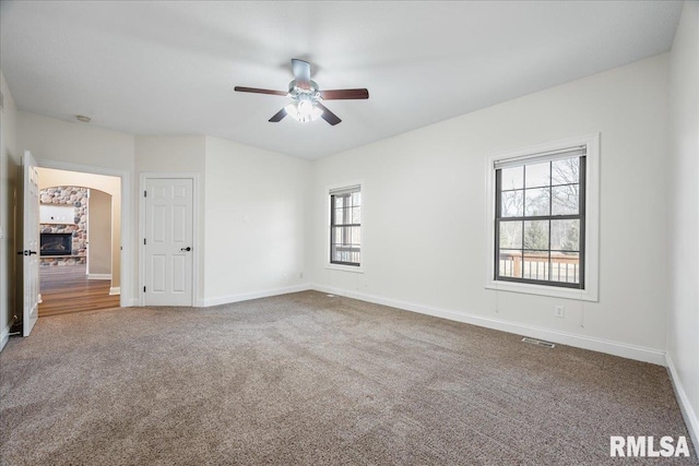 spare room featuring ceiling fan and carpet