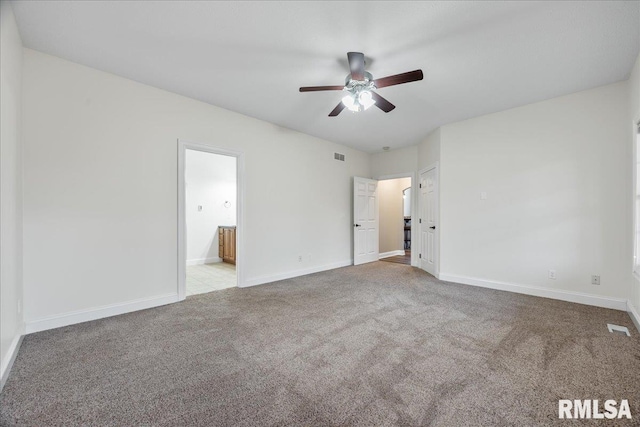 unfurnished bedroom with ensuite bathroom, light colored carpet, and ceiling fan