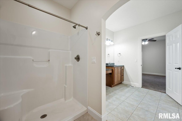 bathroom with vanity, tile patterned flooring, and a shower