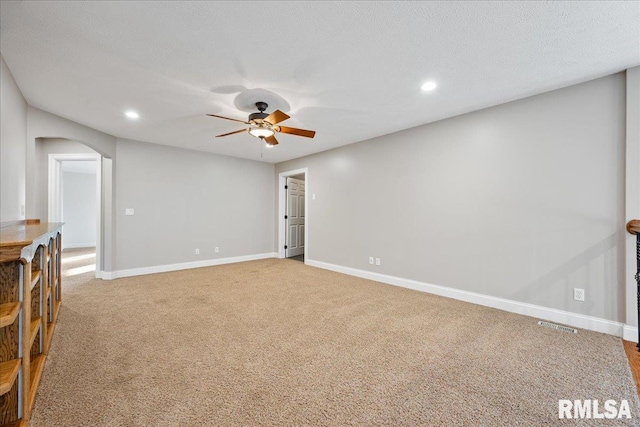 unfurnished room with carpet floors, a textured ceiling, and ceiling fan