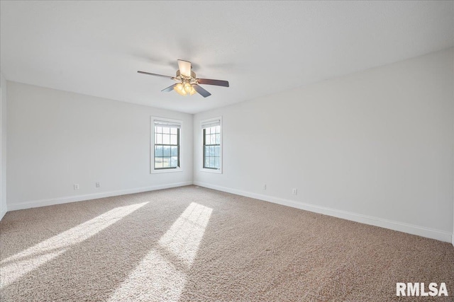 carpeted empty room featuring ceiling fan