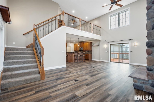 living room featuring ceiling fan and dark hardwood / wood-style flooring